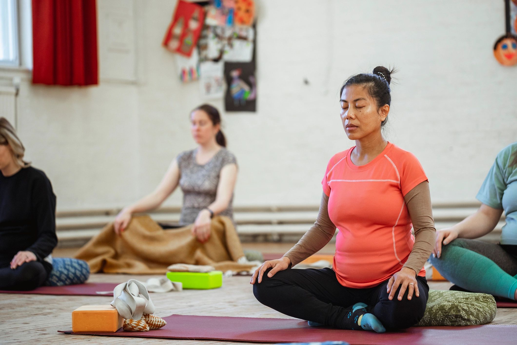 Students seated on yoga mats during class