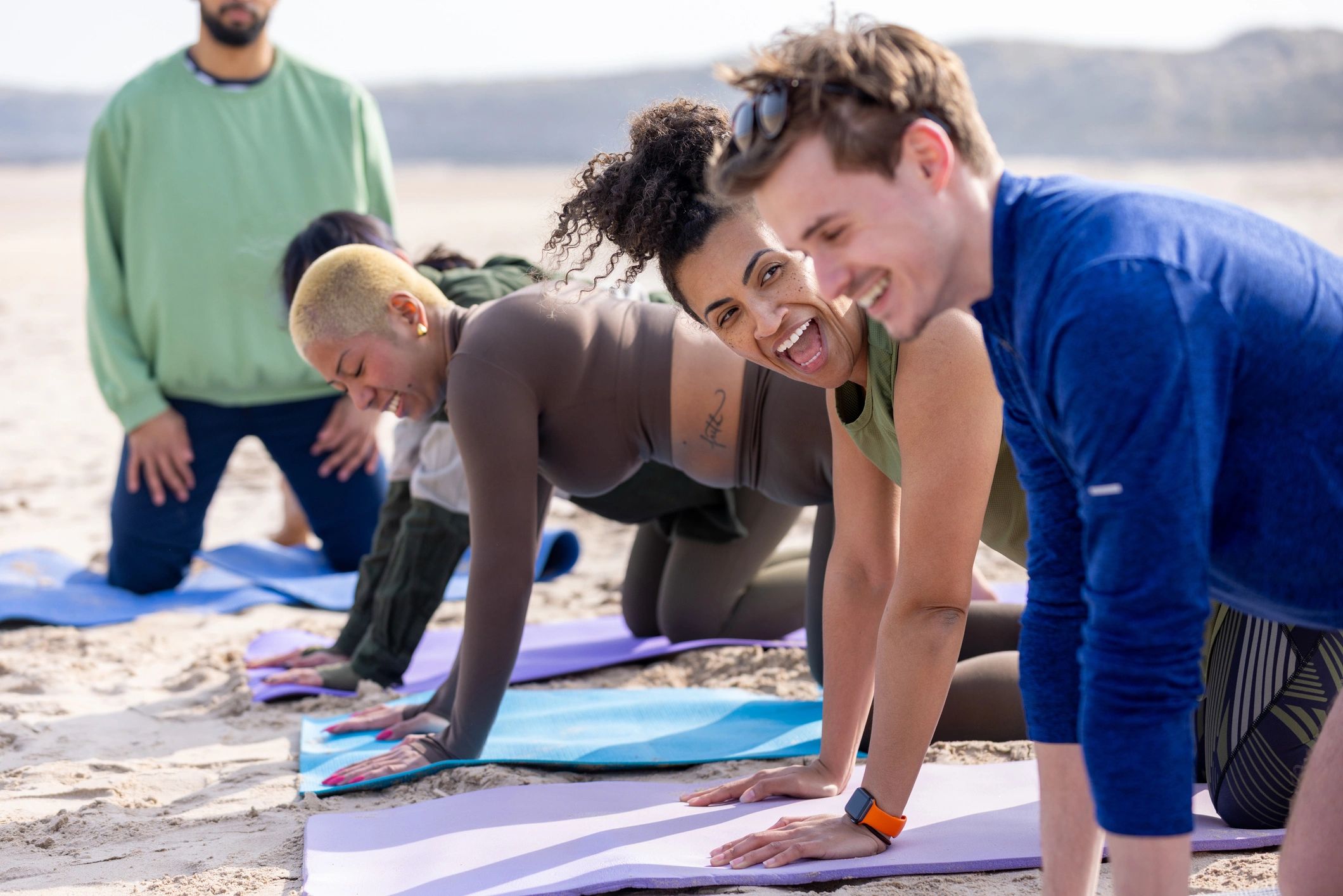 Group yoga class in an energetic studio setting