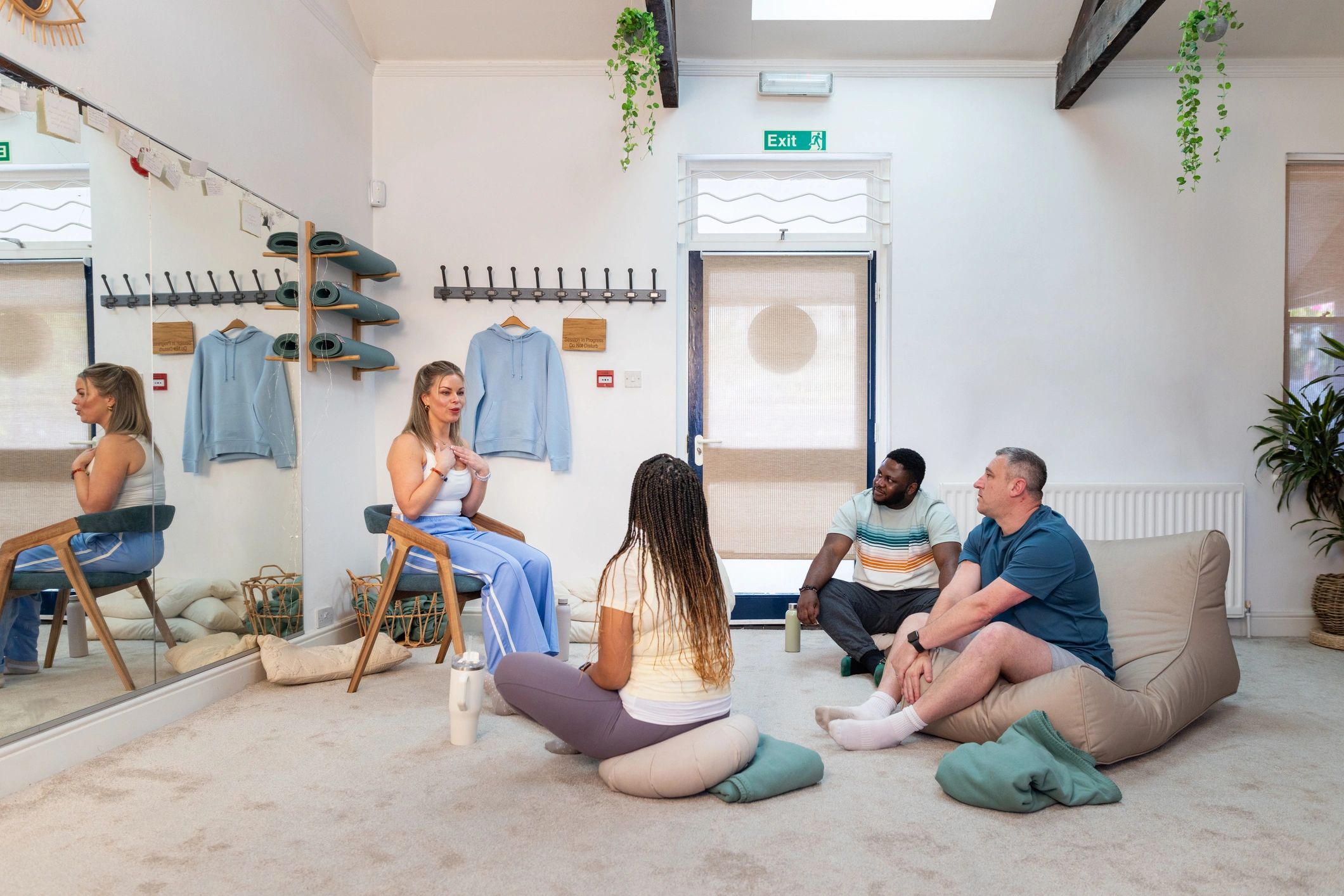 Instructor leading a wellness class in studio